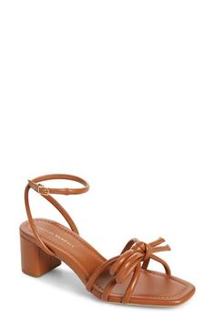 A strappy bow perches atop the toe of this leather sandal lifted on a blocked heel and finished with a squared-off toe. 2 1/4" heel (size 8.5) Leather upper, lining and sole Imported Bow Sandals, Size 11 Heels, Gift Bows, Loeffler Randall, Fabric Gift Bags, Sandal Women, Women's Shoes Sandals, Leather Sandals, Womens Sandals