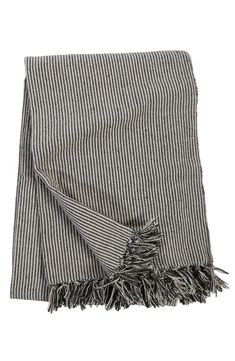 a black and white striped blanket with fringes