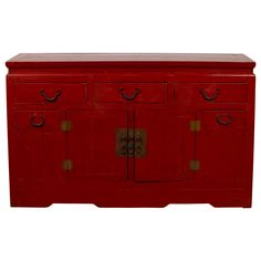 a red cabinet with two doors and three drawers