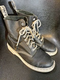 Vintage Dr. Marten Black with White Air Wair Soles and heels Ladies Size 9 to 9.5 Nothing better to bounce around in than a Classic and Cool pair of Docs.  These have the classic air wair bouncing soles and heels.  Also, they are oil resistant. Shoes feature 8 pairs of grommets for lacing up the front and beautiful white stitching, all intact.  Condition is good some scratches on one toe, and one mark on exterior, inside is clean, and chunky white soles and heels are in good condition.  "Dr. Mar Black High Ankle Lace-up Boots Alternative Style, Black Lace-up Ankle Boots With Stitched Sole, Black Lace-up Boots With Stitched Sole For Fall, Alternative Style Black Closed Toe Boots, Alternative Black Closed Toe Boots, Ankle-high Boots For Streetwear, Black Closed Toe Alternative Boots, Black Faux Leather Grunge Boots, Punk High-top Boots With Rubber Sole