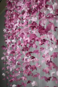 pink paper butterflies hanging from the ceiling