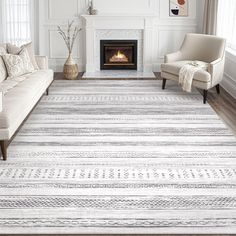 a living room with a fireplace and white furniture