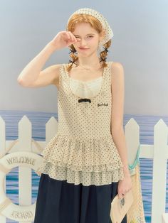 Embrace your sweet and playful side with our charming polka dot sleeveless top. Adorned with a delightful tiered hem and a dainty bowknot, this creamy beige top is a versatile piece that can be paired with various bottoms for a cute and elegant look.  This product just includes one sleeveless top. Garment Size SizeSMLXLFull Length65666768Shoulders32333435Bust889296100 Cute Polka Dot Sleeveless Top, Sleeveless Polka Dot Top For Beach, Polka Dot Sleeveless Tank Top, Sleeveless Polka Dot Summer Tops, Sleeveless Polka Dot Top For Summer, Steampunk Fashion Female, Steampunk Fashion Male, Gothic Skirts, Beige Top