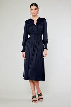 This long-sleeve V-neck midi dress is a vision of sophistication and femininity. The tie-up neckline and ruffle trim add to the allure, and the smocked peplum creates definition at the waist. This one will become a fast favorite. On Average customers say it runs true to size to slightly small •V-neck with tie detail •Ruffle trim •Elasticized waist •Long sleeves •Mid-length hem DIMENSIONS •Standard: 49" Length Item number 2590036CA100% Polyester Gentle cycle cold Dry line Elegant V-neck Smocked Dress For Brunch, Elegant Spring Smocked Dress With Pleated Waist, Elegant Smocked Dress For Spring With Pleated Waist, Workwear Midi Dress With Smocked Bodice, Elegant Midi Dress With Smocked Bodice For Date Night, Blue Workwear Dress With Elastic Sleeves, Chic Smocked Dress For Workwear, Workwear Dresses With Smocked Bodice, Midi Length, Midi Dresses With Smocked Bodice For Work