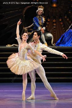 two ballerinas in white and gold tutus on stage