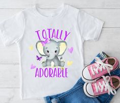 Totally adorable Elephant shirt for your favorite kid! Enjoy our collection of casual baby, toddler and youth fashionable bodysuits, t-shirts and sweatshirts.  Many of our designs have a personalization option - so keep that in mind if you are looking for a personalized baby, kids or youth shirt. -- SHIRT SPECIFICATIONS -- ► Baby/Infant Shirts are 100% ringspun cotton ► Toddler Shirts are 100% ringspun cotton ► Youth Shirts are 100% Cotton Preshrunk ► We use top quality brands and fabrics. ► Our designs are printed with Kid-safe and eco friendly water based inks that are naturally sourced and environmentally friendly. ► Shirt sizing and measurements are shown as photos in each item listing. ► Brands we use are Next Level, Bella Canvas, Rabbit Skins and Gildan -- PERSONALIZATION -- ► If an Cute Cartoon Print Top For First Birthday, Cute Cartoon Print Tops For First Birthday, Cute Top With Name Print For First Birthday, Cute Tops With Name Print For First Birthday, Cute Shirt With Graphic Print For First Birthday, Cute Graphic Print Shirt For First Birthday, Cute Short Sleeve Shirt For First Birthday, Cute Crew Neck Shirt For First Birthday, Cute Tops With Funny Print For First Birthday