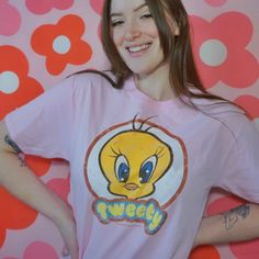 Looney Tunes Retro Tweety T-Shirt This stylish, officially licensed Looney Tunes Retro Tweety T-shirt will be sure to be a hit with any fan. Made from 100% cotton, the t-shirt boasts a classic vintage look that will last through many wears and washes. Show off your love of Tweety with this t-shirt that celebrates the retro look and feel of the beloved character. Officially Licensed 100% Cotton High Quality Pre Shrunk Short Sleeves Color: Pink Printed in the U.S.A. with eco-friendly inks Machine Retro T-shirt With Front Print For Fans, Retro Fan Merchandise T-shirt With Front Print, Retro Pre-shrunk T-shirt For Fan Conventions, Pop Culture T-shirt For Fan Conventions, Retro Character Print T-shirt For Fan Conventions, Pop Culture Fan Merchandise T-shirt With Crew Neck, Retro T-shirt With Screen Print For Fan Conventions, Pop Culture Pre-shrunk Crew Neck T-shirt, Retro Pink T-shirt With Cartoon Print