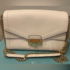 Michael Kors White Shoulder Bag Snap Fastening Trendy White Flap Bag For Formal Occasions, Elegant White Flap Bag For Travel, Classic White Flap Bag For Shopping, White Formal Flap Bag With Branded Hardware, Formal White Flap Bag With Branded Hardware, Elegant White Clutch For Shopping, White Flap Bag With Gold-tone Hardware For Daily Use, Daily Use White Flap Bag With Gold-tone Hardware, Everyday Cream Bag With Chain Strap