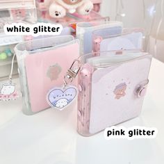 there are two pink glitter bags with tags on them and one has a hello kitty keychain attached to it