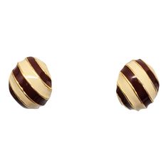 1970s goldtone half hoop red and ivory enamel striped clip earrings. Marked "Bijoux Cascio." Measure: 7/8 inches long by 3/4 inches wide. Condition: Very good; but when looking from the top a small section of enamel is missing from the edge, they may have been made that way & it's not noticeable when worn. There is also a little bit of wear to the backs. Clip Earrings, Vintage 1970s, That Way, Clip On Earrings, 1970s, Gold Tones, Hoop Earrings, Italy, Red