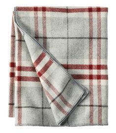 a red and white checkered blanket folded on top of a tablecloth with a gray background