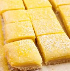 several squares of yellow cake sitting on top of a counter