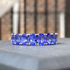 Stunning purplish-blue color, natural tanzanite half eternity band ring handcrafted in 14K solid gold. Made to Order Ship within 3-4 weeks. - Stone info: natural tanzanite - Stone size: 6x4mm - Ct weight: 4.5ctw - Made in 14 karat gold. - Stamp with 14K Year Ring, Tanzanite Jewelry, Tanzanite Stone, Half Eternity Band, Half Eternity Ring, Eternity Band Ring, Natural Tanzanite, Eternity Band, Eternity Bands