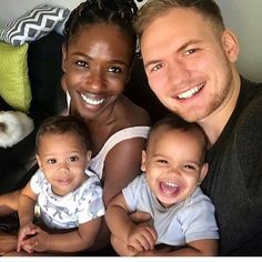 a man, woman and two children are smiling for the camera