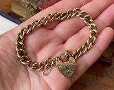 "This item measures approximately 7\" inches in inner circumference.  Lock measures approximately - 2cms in height. Links approximately 0.8cms in width. Altogether It weighs approximately - 21.2gms. It is a beautiful, antique Vintage 9ct gold, charm bracelet, with engraved heart catch. A heavy solid linked bracelet.  Hallmarked to lock and intermittent links but also professionally tested as 9ct gold. Wear and tear expected on an antique item. Box in photographs not included in the sale. Please see photos for a more accurate description." Antique Charm Bracelet, Linked Bracelet, Heart Padlocks, Almandine Garnet, Gold Charm Bracelet, Engraved Bracelet, Garnet Rings, Gold Charm, Antique Items