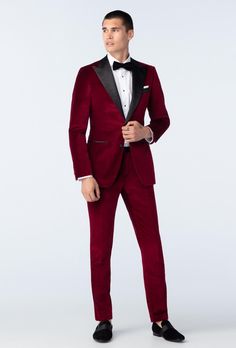 a man in a red tuxedo and black bow tie