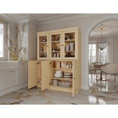 an open cabinet in the middle of a kitchen with white walls and marble flooring