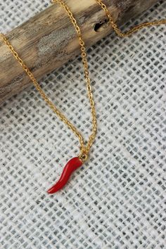 This simple boho necklace was made of red enamel metal horn pendant and gold tone stainless steel cable chain with gold tone lobster claw. The chain is from lead free & nickel free metal. The red horn charm is a symbol of hope and good luck. It is said to repel against evil eye and promote good fortune! So let this necklace bring a great luck to you or to the one you want to give as a gift! Perfect for everyday wear or an unique gift for someone special! The length of necklace is about 46 cm or Red Pendant Chain Necklace With Clavicle Chain, Red Clavicle Chain Pendant Necklace, Dainty Red Necklace With Lobster Clasp, Red Chain Charm Necklace For Gift, Red Chain Necklace With Lobster Clasp As Gift, Gift Red Chain Necklace With Gold Chain, Red Gold Chain Necklace For Gifting, Gift Red Gold Chain Necklace, Handmade Red Chain Necklace As Gift