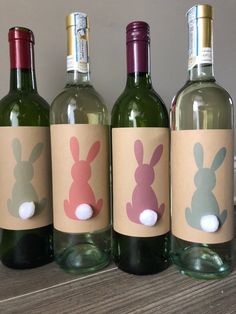 three wine bottles with bunny ears on them