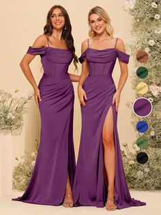 two women in purple dresses standing next to each other with their hands on their hips