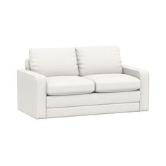 a white couch sitting on top of a white floor