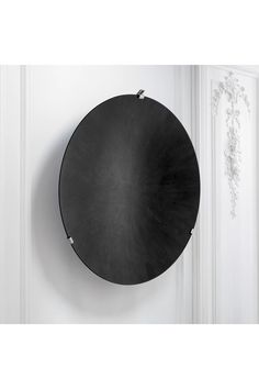 a round black plate hanging on the wall