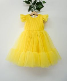 "Beautiful baby girl dress for wedding and birthday party. ----------------- Bodice: Material - soft yellow tulle Lining - 100% cotton fabric Back - zipper back Skirt: Material yellow tulle Lining - satin Length - knee-length -------------------------------- SIZE Chart size 6-12m - chest 19.5, length 18\" size 1T - chest: 20\" , length 19.5 size 2T - chest: 20.5\" , length 21\" size 3T - chest: 21.5\", length 23\" size 4T - chest: 22\", length 24\" size 5 - chest: 23\", length 25\" size 6 - ches Yellow Tulle Wedding Dress, Fitted Yellow Princess Dress For Summer, Yellow Princess Dress For Birthday In Spring, Summer Fairy Dress With Ruffles For First Birthday, Cute Yellow Princess Dress For Party, Yellow Summer Party Tutu Dress, Cute Yellow Princess Party Dress, Yellow Princess Dress For Summer Birthday, Yellow Tutu Dress For Birthday