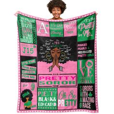 a woman holding up a pink and green blanket with black women's rights on it