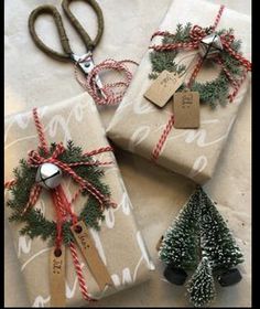 three wrapped presents with christmas trees on them and price tags attached to the wrapping paper