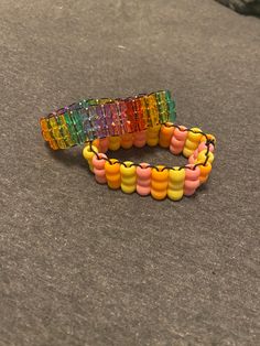 two bracelets made out of gummy bears sitting on the ground next to each other