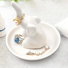 an elephant figurine sitting on top of a white plate next to other items