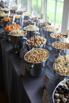 a bunch of buckets filled with food on top of a table