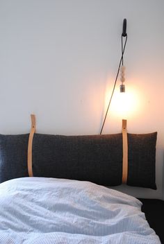 two pieces of wood sticking out of the back of a couch next to a lamp