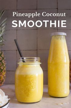 pineapple coconut smoothie in a mason jar next to a glass with a straw