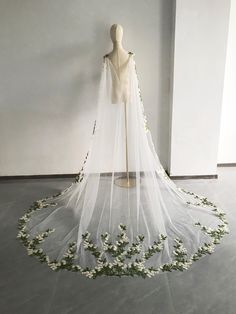 a white wedding veil with flowers on it