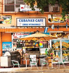 an outdoor cafe with tables and chairs outside