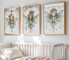 two framed pictures hang on the wall above a crib in a white nursery room