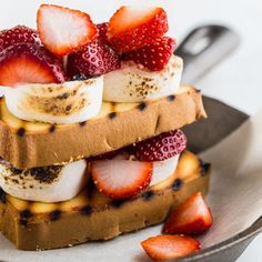 there are bananas and strawberries on top of toast