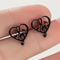 Unique Music Notes And Treble Clef In A Heart Black Stud Earrings. Perfect For Any Musician Or Music Lover. Also Available In Gold Toned, Rose Gold Toned And Silver Toned. Black Earrings For Valentine's Day, Black Metal Earrings For Valentine's Day, Black Heart Earrings As A Gift, Black Heart Earrings For Pierced Ears As Gift, Black Heart-shaped Earrings For Gift, Black Valentine's Day Earrings, Black Music-themed Jewelry For Gift, Music-themed Black Jewelry Gift, Black Heart-shaped Pierced-style Jewelry