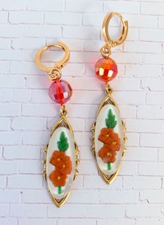 Fascinating vintage relief Lucite cabochons mounted on high-end sturdy stamped brass pieces with lustrous faceted beads for a little added shimmer. Classic versatile earrings that will complement so many wardrobe options. If these caught your eye, you may also like the Bluebell https://etsy.me/35X8fJg or the Chrysanthemum https://etsy.me/3CIEHv1 These make a special gift too! Thanks for looking! Vintage Handmade Brass Clip-on Earrings, Handmade Vintage Brass Clip-on Earrings, Handmade Adjustable Vintage Clip-on Earrings, Handmade Retro Gold Earrings, Vintage Enamel Flower Earrings, Vintage Czech Glass Matching Earrings, Vintage Gold Flower Earrings With Enamel, Vintage Copper Dangle Jewelry, Retro Earrings With Vintage Charm For Gift