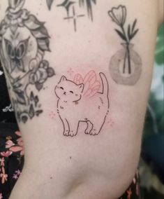 a cat tattoo on the back of a woman's left arm