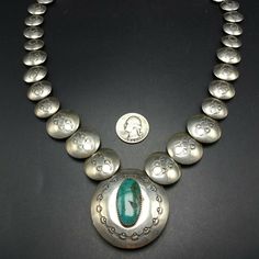 "VINTAGE NAVAJO NECKLACE DESCRIPTION: This fabulous necklace features hand-stamped graduated round pillow beads and a center pendant with turquoise cabochon on one side and storyteller images on the reverse. Curved sterling silver end cones at the terminals. This exciting necklace will be a valuable addition to your collection of fine vintage Native American jewelry. MEASUREMENTS: Necklace measures 24\" end to end Central pendant measures 1 7/8\" across Pillow beads measure from 16mm to 24mm acr Bohemian Stamped Turquoise Necklace, Turquoise Medallion Necklace Engraved, Vintage Silver Turquoise Necklace With Round Beads, Antique Stamped Turquoise Jewelry, Vintage Turquoise Stamped Jewelry, Vintage Turquoise Engraved Necklace, Vintage Stamped Turquoise Jewelry, Vintage Engraved Turquoise Necklace, Adjustable Vintage Silver Turquoise Necklace