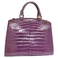 This is the most iconic and beautiful piece to add to your collection! A bag made to make a statement! This bag is vintage, made in 2001, and is perfect for the Louis Vuitton collector. It is featured in a beautiful and subtle but brilliant purple made of crocodile leather. The beautiful leather of this bag is the star but is complimented by small gold metal accents. This bag features metal feet and a cute "Louis Vuitton" round charm. Zoom in to see all the subtle "Louis Vuitton" branding on the gold embellishments. It includes a crossbody strap. This bag is in excellent condition with no notable flaws. The interior is in beautiful condition and made from a purple canvas with two large slip pockets and a zip pocket. Pair this bag with a Bottega Veneta dress and some Hermes Sandals and you Bottega Veneta Dress, Hermes Sandals, Purple Canvas, Metal Accents, Crocodile Leather, Metallic Accents, Crossbody Strap, A Bag, Monster High