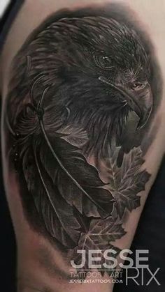 an eagle with leaves on it's back is shown in this black and grey tattoo