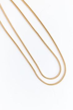 - Layer on the charm with this simply chic necklace! - Gold colored brass material - Two connected chain strands for a layered look - Adjustable length chain and clasp closure - Size: 14.5-17.5 inches Gold Double Chain Charm Necklace For Everyday, Everyday Gold Double Chain Charm Necklace, Minimalist Double Strand Gold Chain Necklaces, Gold Metal Charm Necklaces For Layering, Gold Double Snake Chain Necklace, Everyday Double Chain Gold-tone Necklace, Minimalist Gold Link Layered Necklace, Everyday Gold Layered Chain Necklace, Everyday Gold-tone Double Chain Necklace