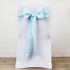 the back of a white chair with a light blue bow on it's sash