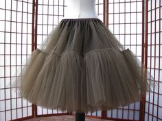 "This listing is for a custom version of the tulle skirt shown in the photos. There are 8 layers of 100% nylon tulle with each layer having two tiers. The waistband is .75\" (2 cm) wide elastic within a polyester satin casing. The upper tier of the skirt is lined with the same polyester satin. The skirt in the photos was made to fit a 33\" (84cm) waist and is 25\" (64cm) long. WAIST: Please select your waist from the listed ranges in inches or centimeters which will determine the price. LENGTH: Tule Rok, Polyester Satin, Petticoat, Chocolate Brown, Custom Sizing, Tulle Skirt, Ballet Skirt, Womens Skirt, Bathing Beauties