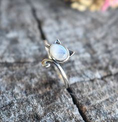 Cat Ring Details:-Choice of Natural Rainbow Moonstone, Dominican Larimar, or Natural Amethyst- 12mm face height- 2mm smooth round band- .925 solid sterling silver- Available in US ring sizes 4-10.5 with 1/2 sizes. 💜Connect with us on Instagram @a_wild_violet for sales and giveaways!**All items are in stock and ship within 2-5 business days from received payment (excluding Saturday/Sunday) from the US. If you are within the US please expect 3-7 business days for shipping transit and delivery. In Adjustable Spiritual Moonstone Ring, Adjustable Moonstone Jewelry With Round Stone, Adjustable Round Moonstone Jewelry, Adjustable Moonstone Birthstone Ring, Mystical Round Natural Stones Jewelry, Mystical Round Cabochon Jewelry, Mystical Round Natural Stone Jewelry, Hypoallergenic Adjustable Jewelry With Round Stone, Mystical Round Moonstone Jewelry