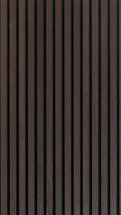 the side of a wooden wall with vertical slats in brown and black woodgrain