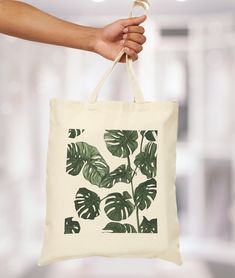 Monstera tote bag, plant lover tote bag, jute beutel, monstera, plants - This 100% cotton bag comes in one size - 15" x 16"- perfect for everyday wear.  - The bag features 20" handles (made from the same canvas), making it easy to carry even with a week's worth of shopping. - 100% cotton canvas - Heavy fabric (12 oz/yd² (406.9 g/m Botanical Style Everyday Tote Bag, Botanical Cotton Tote Bag, Cotton Bags With Plant Print For Everyday Use, Botanical Style Cotton Tote Bag, Botanical Bags With Plant Print For Everyday Use, Botanical Bags With Plant Print And Rectangular Shape, Everyday Botanical Bags With Plant Print, Everyday Botanical Style Bag With Plant Print, Botanical Style Rectangular Bag With Plants Print